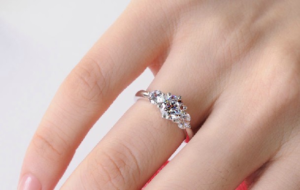 3 stone engagement rings on finger