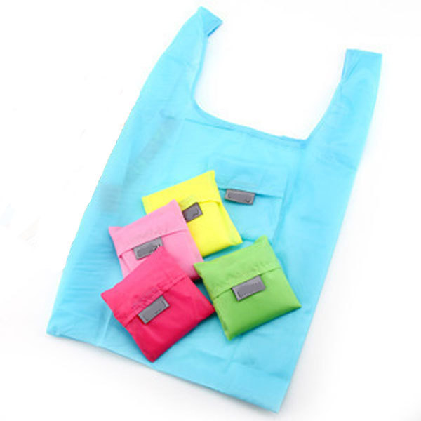 multi colored reusable bags. one is open and four are folded on top of the open bag